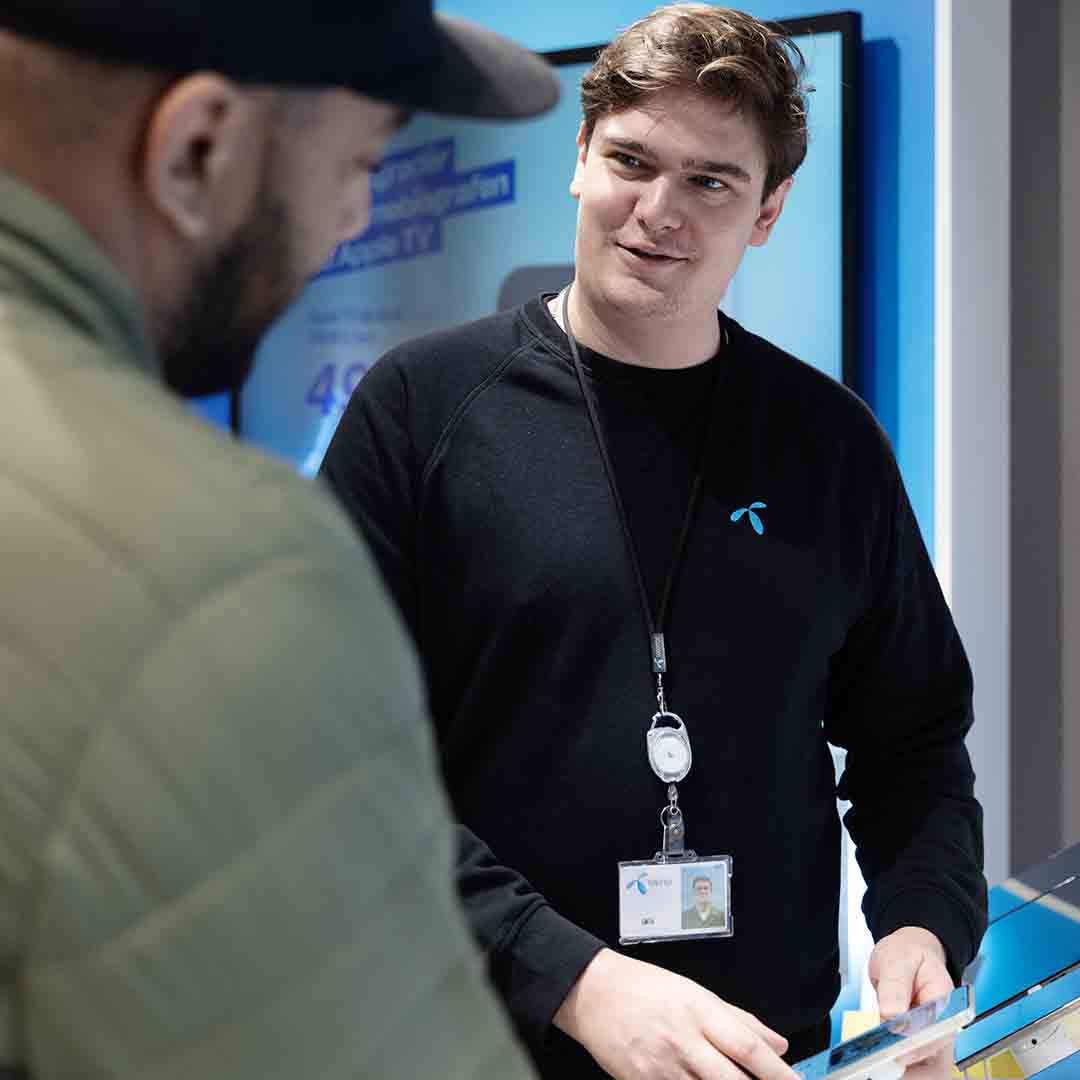 Employee from Telenor in Frederiksberg talks to a customer.